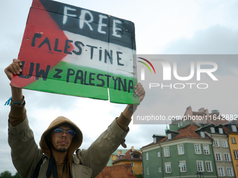 A man holds a sign during a Palestine support rally in Warsaw, Poland on 05 October, 2024. About a hundred people marched from the Royal Cas...