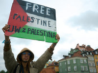 A man holds a sign during a Palestine support rally in Warsaw, Poland on 05 October, 2024. About a hundred people marched from the Royal Cas...