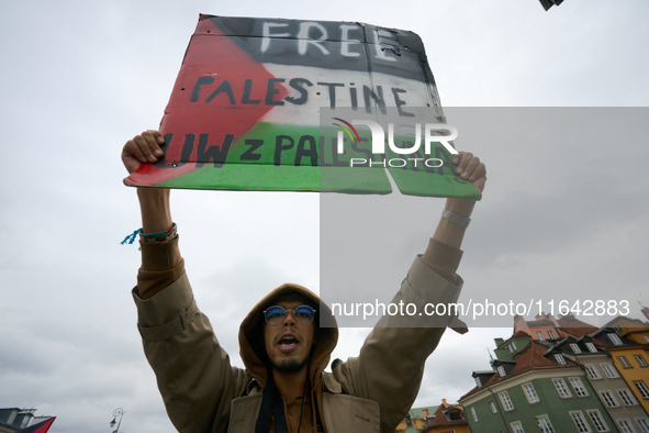 A man holds a sign during a Palestine support rally in Warsaw, Poland on 05 October, 2024. About a hundred people marched from the Royal Cas...