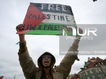 A man holds a sign during a Palestine support rally in Warsaw, Poland on 05 October, 2024. About a hundred people marched from the Royal Cas...