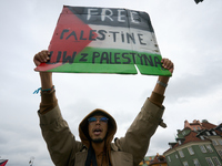 A man holds a sign during a Palestine support rally in Warsaw, Poland on 05 October, 2024. About a hundred people marched from the Royal Cas...