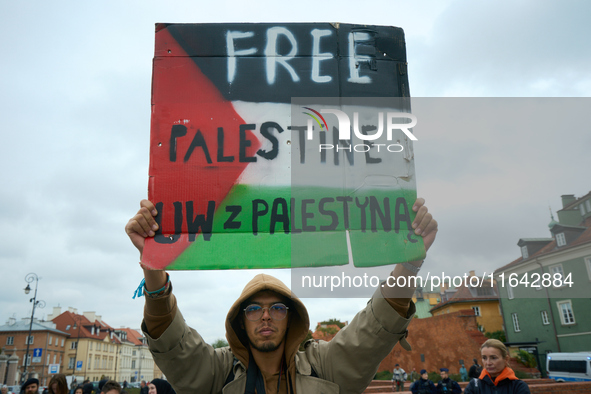 A man holds a sign during a Palestine support rally in Warsaw, Poland on 05 October, 2024. About a hundred people marched from the Royal Cas...