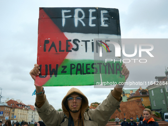 A man holds a sign during a Palestine support rally in Warsaw, Poland on 05 October, 2024. About a hundred people marched from the Royal Cas...