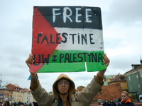 A man holds a sign during a Palestine support rally in Warsaw, Poland on 05 October, 2024. About a hundred people marched from the Royal Cas...