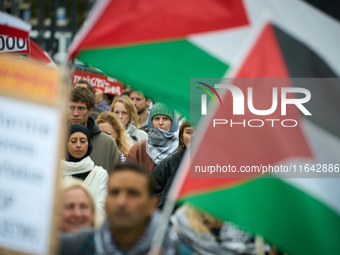 People take part in a rally in support of Palestine and Gaza in Warsaw, Poland on 05 October, 2024. About a hundred people marched from the...