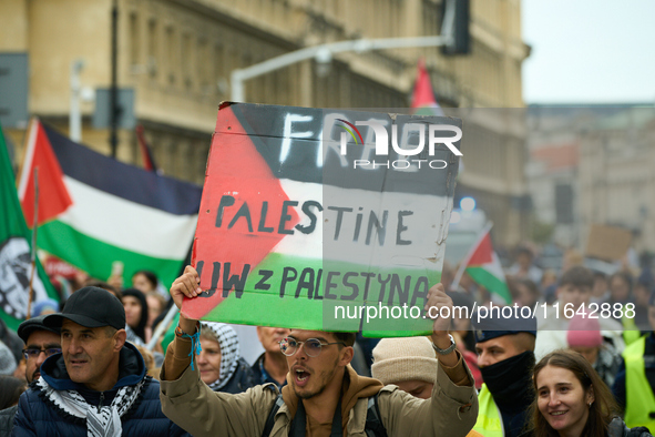 A man holds a sign during a Palestine support rally in Warsaw, Poland on 05 October, 2024. About a hundred people marched from the Royal Cas...