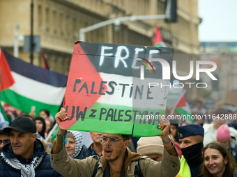 A man holds a sign during a Palestine support rally in Warsaw, Poland on 05 October, 2024. About a hundred people marched from the Royal Cas...