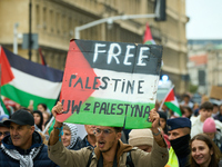 A man holds a sign during a Palestine support rally in Warsaw, Poland on 05 October, 2024. About a hundred people marched from the Royal Cas...