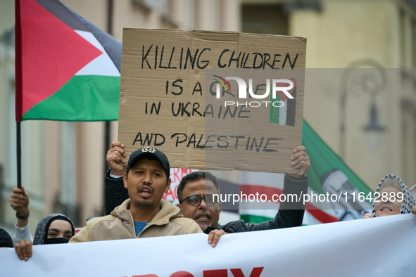 A man holds a sign during a Palestine support rally in Warsaw, Poland on 05 October, 2024. About a hundred people marched from the Royal Cas...