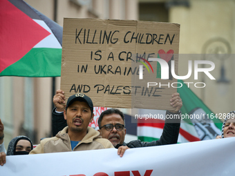 A man holds a sign during a Palestine support rally in Warsaw, Poland on 05 October, 2024. About a hundred people marched from the Royal Cas...