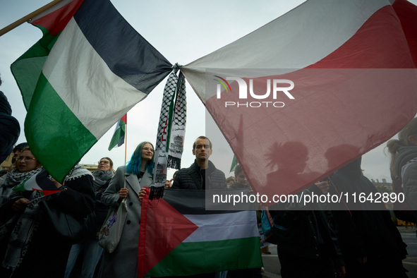 A woman holds a Palestinian flag during a rally in Warsaw, Poland on 05 October, 2024. About a hundred people marched from the Royal Castle...