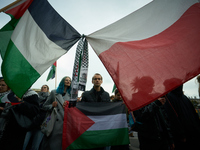 A woman holds a Palestinian flag during a rally in Warsaw, Poland on 05 October, 2024. About a hundred people marched from the Royal Castle...