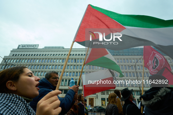 A woman holds a Palestinian flag during a rally in Warsaw, Poland on 05 October, 2024. About a hundred people marched from the Royal Castle...