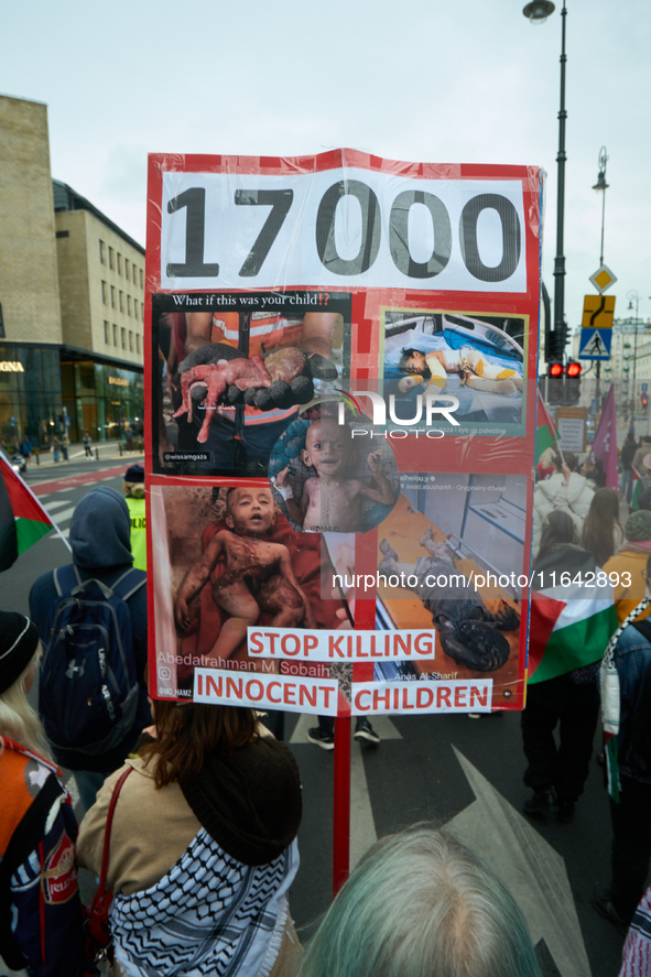 A woman holds a sign with images of dead children during a Palestine support rally in Warsaw, Poland on 05 October, 2024. About a hundred pe...