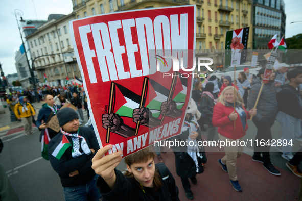 A woman holds up a sign during a Palestine support rally in Warsaw, Poland on 05 October, 2024. About a hundred people marched from the Roya...