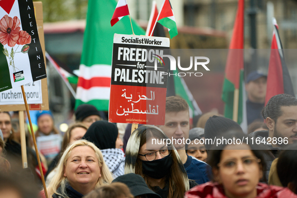 A protester holds a sign in Warsaw, Poland on 05 October, 2024. About a hundred people marched from the Royal Castle Square to the US embass...