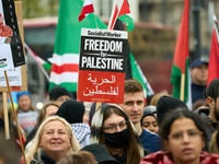 A protester holds a sign in Warsaw, Poland on 05 October, 2024. About a hundred people marched from the Royal Castle Square to the US embass...