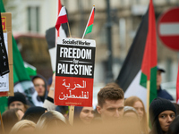 A protester holds a sign in Warsaw, Poland on 05 October, 2024. About a hundred people marched from the Royal Castle Square to the US embass...