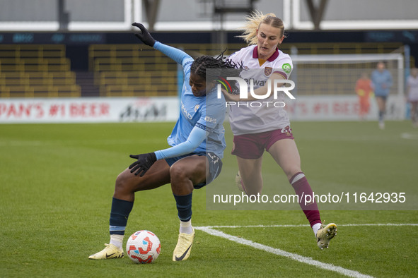 Khadija Shaw #21 of Manchester City W.F.C. is challenged by Shannon Cooke #21 of West Ham United F.C. during the Barclays FA Women's Super L...