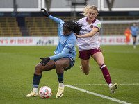 Khadija Shaw #21 of Manchester City W.F.C. is challenged by Shannon Cooke #21 of West Ham United F.C. during the Barclays FA Women's Super L...