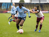 Khadija Shaw #21 of Manchester City W.F.C. is challenged by Camila Saez #17 of West Ham United F.C. during the Barclays FA Women's Super Lea...