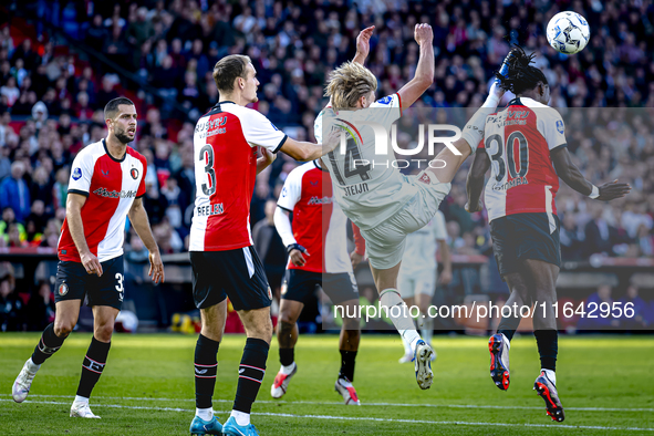 Feyenoord Rotterdam defender Thomas Beelen, FC Twente midfielder Sem Steijn, and Feyenoord Rotterdam defender Jordan Lotomba participate dur...