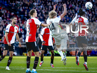 Feyenoord Rotterdam defender Thomas Beelen, FC Twente midfielder Sem Steijn, and Feyenoord Rotterdam defender Jordan Lotomba participate dur...