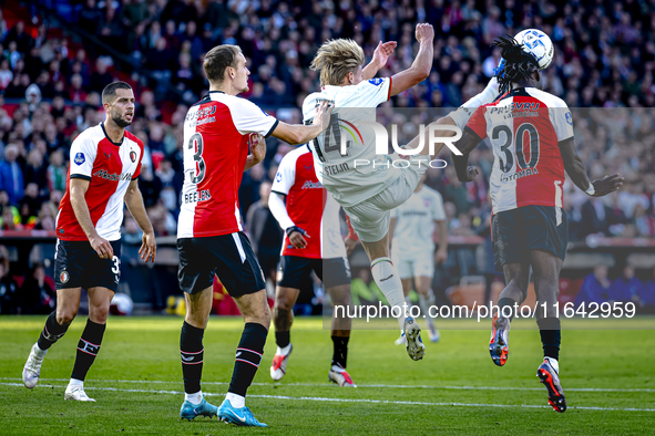 Feyenoord Rotterdam defender Thomas Beelen, FC Twente midfielder Sem Steijn, and Feyenoord Rotterdam defender Jordan Lotomba participate dur...