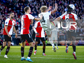 Feyenoord Rotterdam defender Thomas Beelen, FC Twente midfielder Sem Steijn, and Feyenoord Rotterdam defender Jordan Lotomba participate dur...