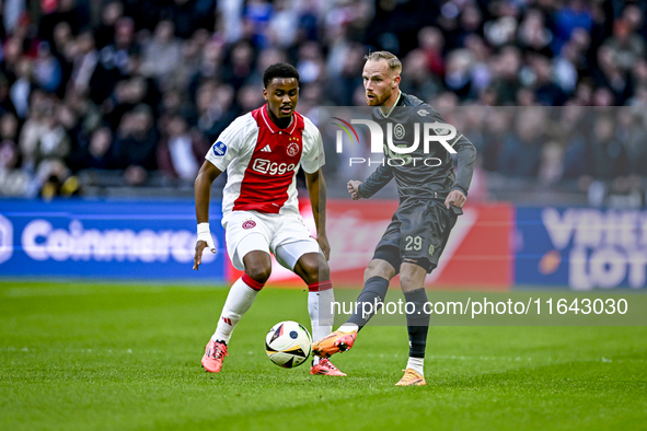 AFC Ajax Amsterdam defender Jorrel Hato and FC Groningen forward Romano Postema play during the match between Ajax and Groningen at the Joha...