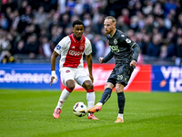 AFC Ajax Amsterdam defender Jorrel Hato and FC Groningen forward Romano Postema play during the match between Ajax and Groningen at the Joha...