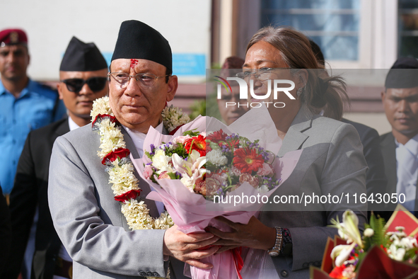 Nepal's new Chief Justice Prakashman Singh Raut (left in garland) is welcomed by Senior Supreme Court Judge Sapana Pradhan Malla (right) upo...