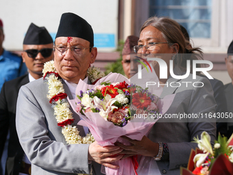 Nepal's new Chief Justice Prakashman Singh Raut (left in garland) is welcomed by Senior Supreme Court Judge Sapana Pradhan Malla (right) upo...