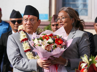 Nepal's new Chief Justice Prakashman Singh Raut (left in garland) is welcomed by Senior Supreme Court Judge Sapana Pradhan Malla (right) upo...