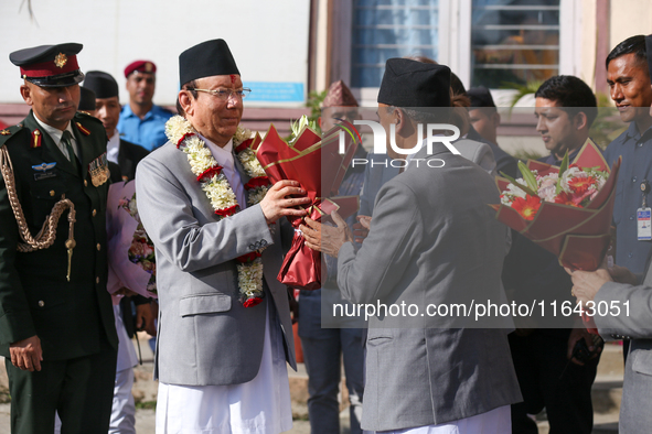 Nepal's new Chief Justice Prakashman Singh Raut (left in garland) is welcomed by Supreme Court justices and officials upon his arrival at th...