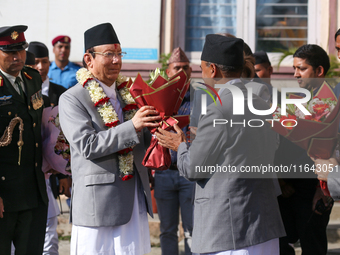 Nepal's new Chief Justice Prakashman Singh Raut (left in garland) is welcomed by Supreme Court justices and officials upon his arrival at th...