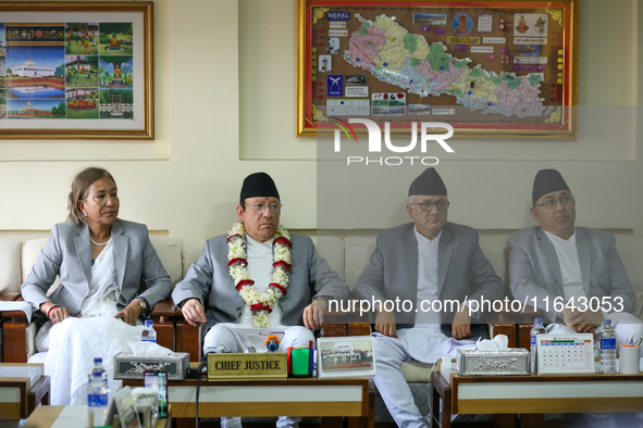 Nepal's new Chief Justice Prakashman Singh Raut (second from left, in garland) is pictured during a press meet at the Supreme Court after ta...