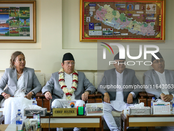 Nepal's new Chief Justice Prakashman Singh Raut (second from left, in garland) is pictured during a press meet at the Supreme Court after ta...