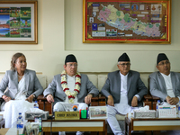 Nepal's new Chief Justice Prakashman Singh Raut (second from left, in garland) is pictured during a press meet at the Supreme Court after ta...