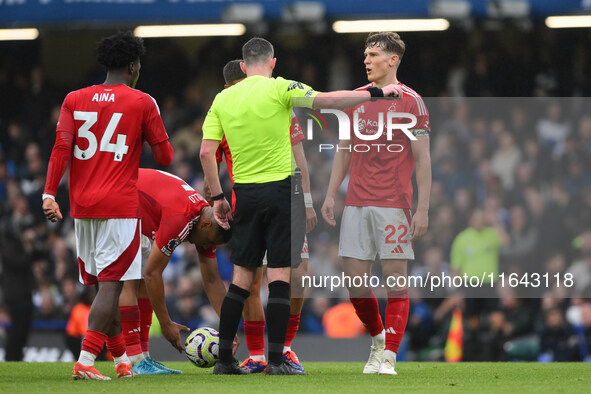 Ryan Yates of Nottingham Forest speaks with Referee Chris Kavanagh during the Premier League match between Chelsea and Nottingham Forest at...