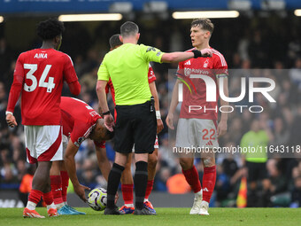 Ryan Yates of Nottingham Forest speaks with Referee Chris Kavanagh during the Premier League match between Chelsea and Nottingham Forest at...