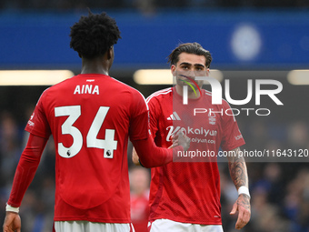 Ola Aina of Nottingham Forest and Jota Silva of Nottingham Forest shake hands during the Premier League match between Chelsea and Nottingham...