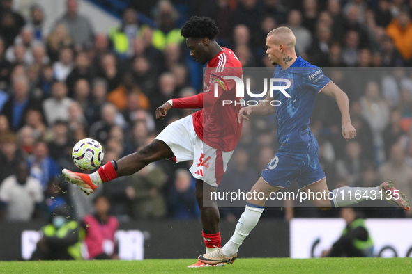 Ola Aina of Nottingham Forest is under pressure from Mykhaylo Mudryk of Chelsea during the Premier League match between Chelsea and Nottingh...