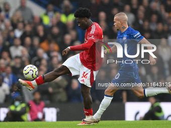 Ola Aina of Nottingham Forest is under pressure from Mykhaylo Mudryk of Chelsea during the Premier League match between Chelsea and Nottingh...