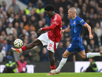 Ola Aina of Nottingham Forest is under pressure from Mykhaylo Mudryk of Chelsea during the Premier League match between Chelsea and Nottingh...