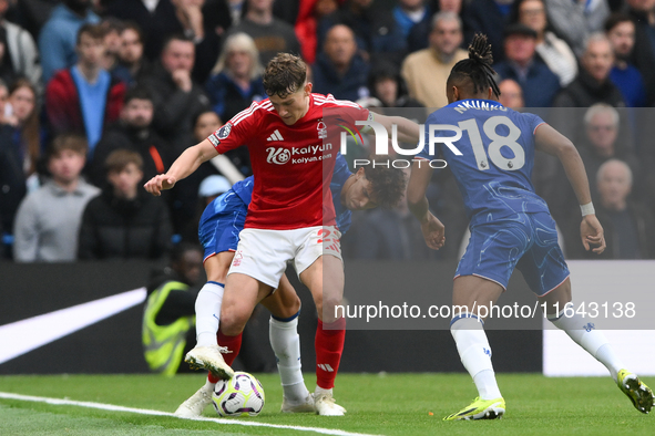 Ryan Yates of Nottingham Forest shields the ball from Joao Felix of Chelsea and Christopher Nkunku of Chelsea during the Premier League matc...