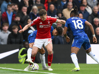 Ryan Yates of Nottingham Forest shields the ball from Joao Felix of Chelsea and Christopher Nkunku of Chelsea during the Premier League matc...