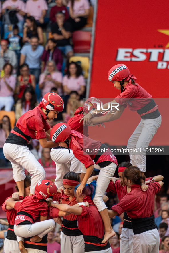 Children of Nens del Vendrell build the final part of the human tower during the Concurs de Castells competition in Tarragona, Spain, on Oct...