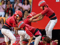 Children of Nens del Vendrell build the final part of the human tower during the Concurs de Castells competition in Tarragona, Spain, on Oct...