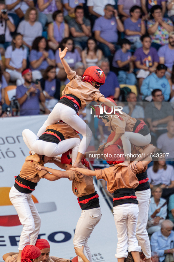 Children of Xiquets de Reus build the final part of the human tower during the Concurs de Castells competition in Tarragona, Spain, on Octob...